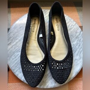 Black flats with small cutouts